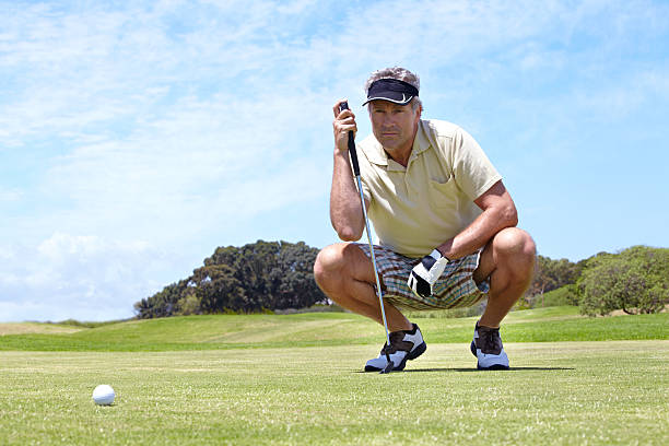 Golf equipment for seniors - pic of a senior lining up his putt.