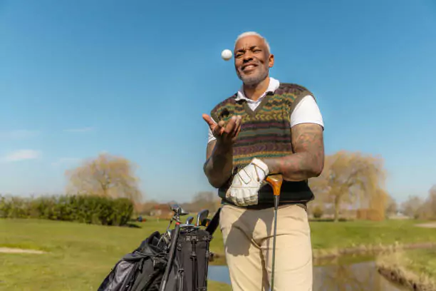 Golf equipment for seniors - pic of a senior with his golfclubs. . 
