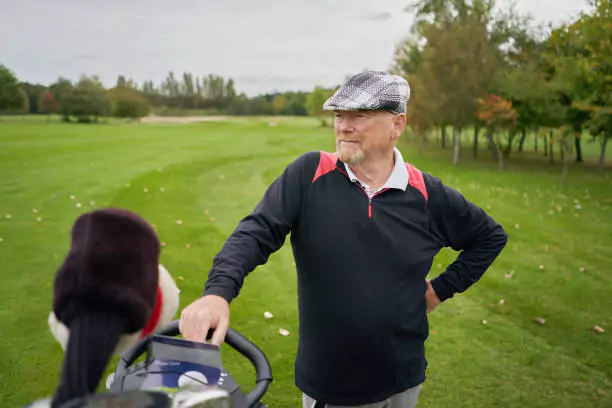 Golf equipment for seniors - pic of a senior waiting to hit his golf ball.